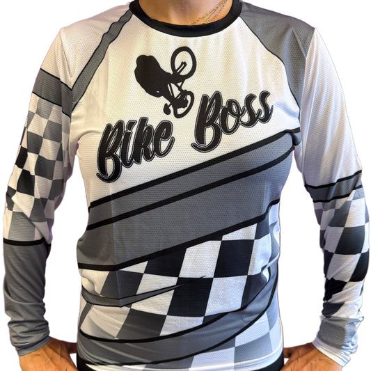 Person wearing a checkered long-sleeve shirt and black shorts with 'Bike Boss' text on a purple background